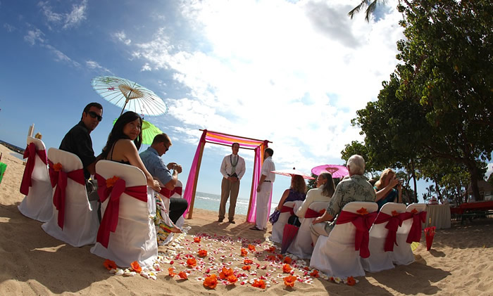 The groom standing under the bamboo alter at Paradise park on the west side of Oahu waiting for the bride to enter at his beach wedding